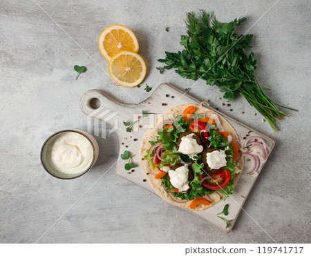 Tortilla with falafel and vegetable salad, white sauce, Arabic cuisine, top view, homemade, no people, vegetarian food, Tortilla with falafel and vegetable salad, white sauce, Arabic cuisine, top view, homemade, no people, vegetarian food, 119741717