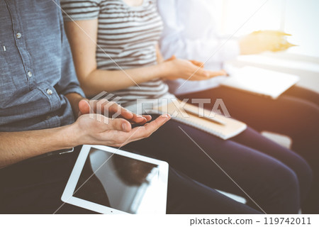 Business people clapping at meeting or conference, close-up of hands. Group of unknown businessmen and women in sunny office Business people clapping at meeting or conference, close-up of hands. Group of unknown businessmen and women in sunny office 119742011