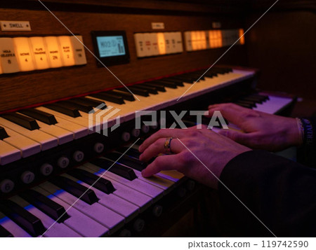 A man plays an electronic organ A man plays an electronic organ 119742590