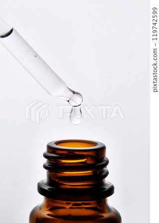 Close-up of a brown cosmetic bottle with a pipette. 119742599
