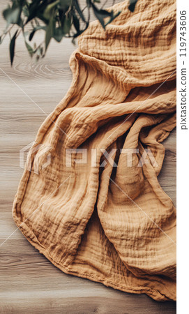 Top-down view of worn blanket on wood floor 119743606