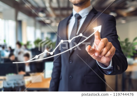 Businessman pointing growing business graph in office 119744476