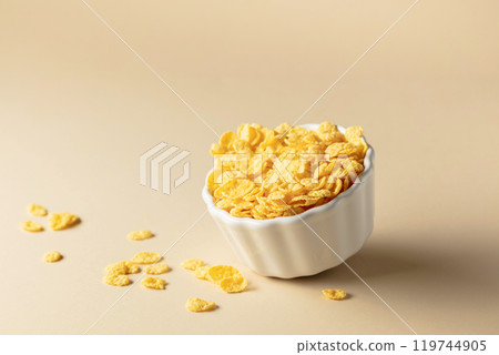 Dry honey cornflakes in a ceramic plate. Dry honey cornflakes in a ceramic plate. 119744905