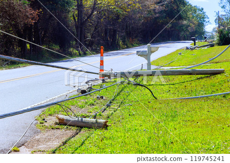 Violent hurricanes caused electrical poles to crash to ground with broken wires during powerful winds Violent hurricanes caused electrical poles to crash to ground with broken wires during powerful winds 119745241