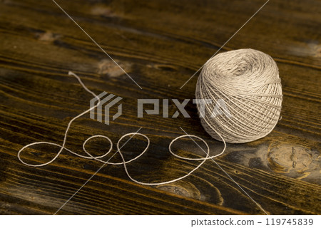 a new skein of grey thread is used for sewing a new skein of grey thread is used for sewing 119745839