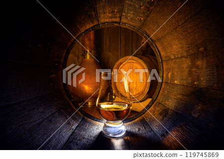 A glass of bourbon Whiskey in oak barrel 119745869