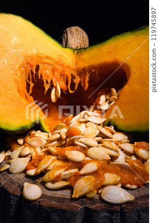 Cutting orange pumpkin with seeds close up Cutting orange pumpkin with seeds close up 119745897
