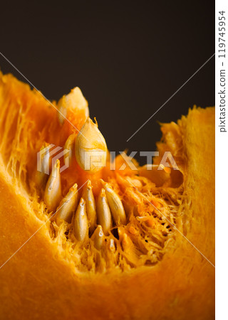 Piece of orange pumpkin with seeds close up Piece of orange pumpkin with seeds close up 119745954