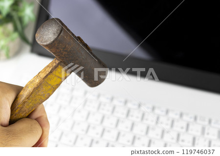Image of a man smashing a laptop with a hammer (man, hands, no face) Image of a man smashing a laptop with a hammer (man, hands, no face) 119746037