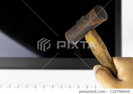 Image of a man smashing a laptop with a hammer (man, hands, no face) Image of a man smashing a laptop with a hammer (man, hands, no face) 119746040