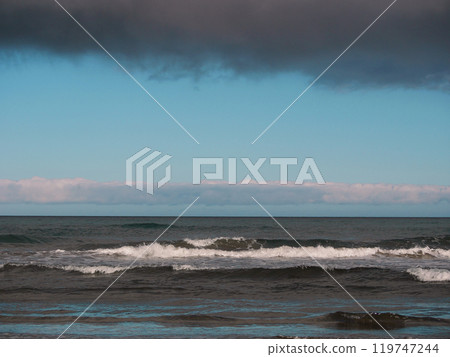 Sea with waves at dusk under a cloudy sky, Gran Canaria. Seascape background wallpaper with copy space 119747244