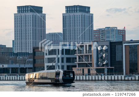 Electric river tram on the Moskva River at sunset on an autumn evening. 119747266
