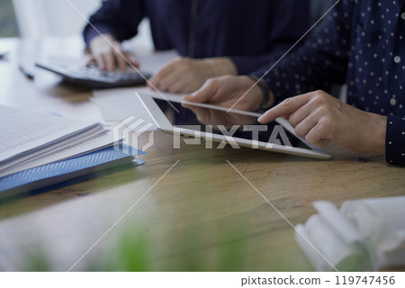 Accountants or auditors reviewing financial documents while sitt Accountants or auditors reviewing financial documents while sitt 119747456