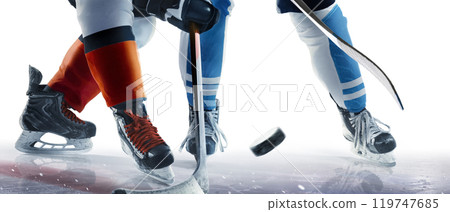 Hockey skates, stick and puck close-up. Two hockey players in ice arena in action. Focus on the puck. Ice rink. Isolated Hockey skates, stick and puck close-up. Two hockey players in ice arena in action. Focus on the puck. Ice rink. Isolated 119747685