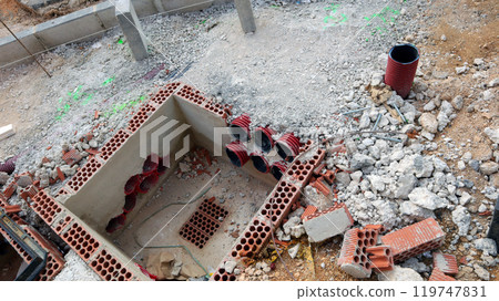 Construction site showing brick laying and utility preparations for street upgrade in early morning light 119747831