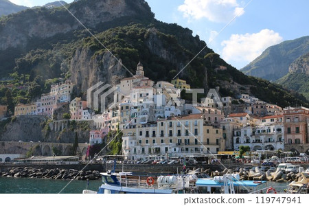 Amalfi, a city of houses lined up on a narrow strip of land surrounded by cliffs Amalfi, a city of houses lined up on a narrow strip of land surrounded by cliffs 119747941
