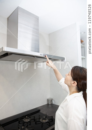 Range hood, Japanese woman operating it Range hood, Japanese woman operating it 119748526