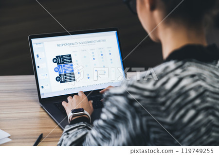 Crop unrecognizable female trader analyzing diagrams in tablet 119749255
