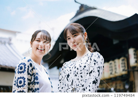 Young woman enjoying sightseeing in Osaka with friends Young woman enjoying sightseeing in Osaka with friends 119749484