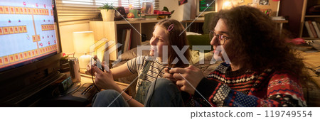 Enjoying a Classic Video Game Together in Cozy Room 119749554