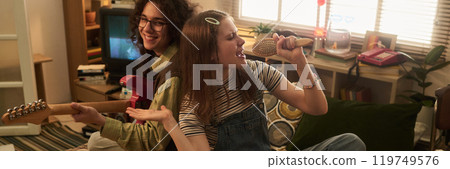 Singing and Playing Guitar in Cozy Living Room Scene 119749576