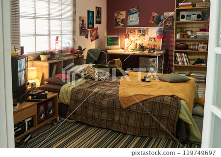 Comfortable Study Setup in Cozy Bedroom with Wall Posters 119749697