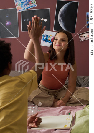 Children High-fiving While Studying Space Themed Posters Children High-fiving While Studying Space Themed Posters 119749750