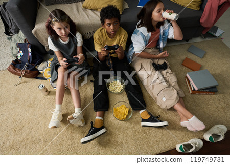 Playing Video Games with Friends in Cozy Living Room 119749781