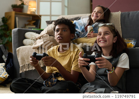 Enjoying Multiplayer Video Game Session at Home Enjoying Multiplayer Video Game Session at Home 119749791