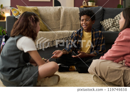 Three Children Engaging in Indoor Playtime at Cozy Home 119749838