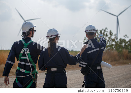 Team engineer wind turbine worker safety uniform survey discuss operational planning windmill field clean energy. Alternative technology protect environment reduce global warming problems. 119750539