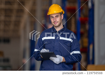 Man paper warehouse worker holding tablet checking inspecting quality cardboard corrugated carton in storage. Large industry in paper product line manufacturing. Man paper warehouse worker holding tablet checking inspecting quality cardboard corrugated carton in storage. Large industry in paper product line manufacturing. 119750588