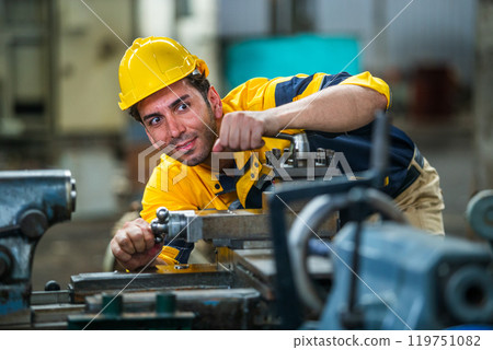 Caucasian man engineering workers wear yellow hard hat working machine lathe metal in factory industrial. mechanical operator male worker. Heavy industry concept. 119751082
