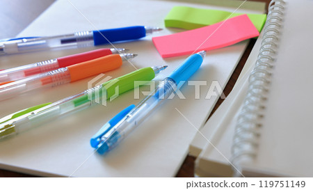 On a desk studying for university entrance exams or qualifications, colorful pens, notebooks and reference books 119751149