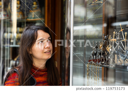 Female traveler viewing forged souvenirs in gift shop of Toledo Female traveler viewing forged souvenirs in gift shop of Toledo 119753173