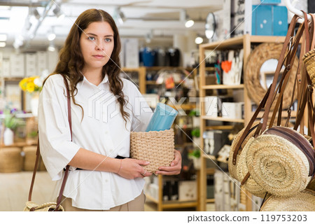 Woman buyer standing in shopping room with decor for home 119753203