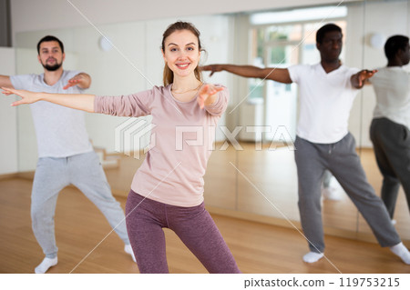 Woman and men dancing in fitness studio 119753215