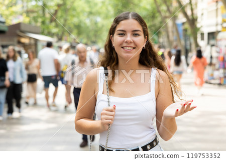 Cheerful girl enjoying walk along La Rambla in summer Barcelona 119753352