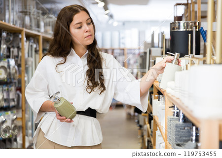 Female shopper choosing bath deodorant at hardware store 119753455