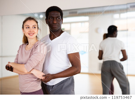 Woman and man practicing waltz in dancing studio 119753467