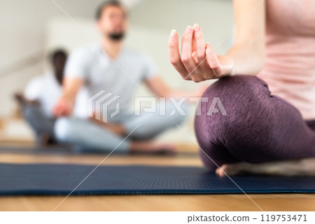Female hand with fingers folded in mudra lying on knee Female hand with fingers folded in mudra lying on knee 119753471