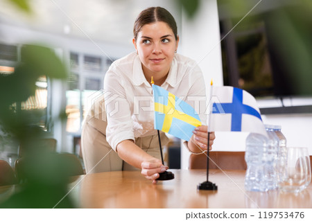 female assistant prepares conference room for diplomats of Finland and Sweden female assistant prepares conference room for diplomats of Finland and Sweden 119753476