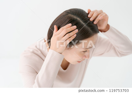 A woman who cares about her hair roots A woman who cares about her hair roots 119753703