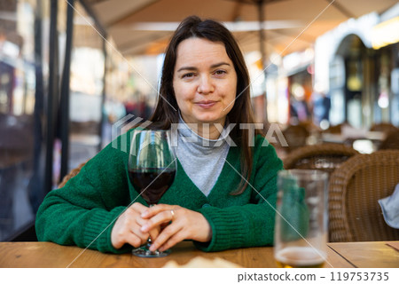 Young adult woman drinking wine at restaurant 119753735