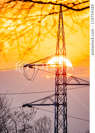 A Beautiful Sunset Behind Power Lines, Where Nature Harmoniously Meets the Industrial World 119754389