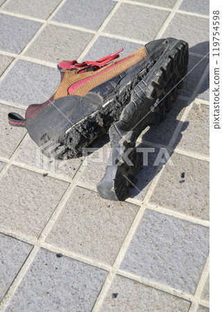Hiking shoes with torn soles 119754598