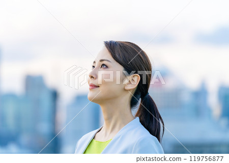 A woman looking far in front of the city 119756877