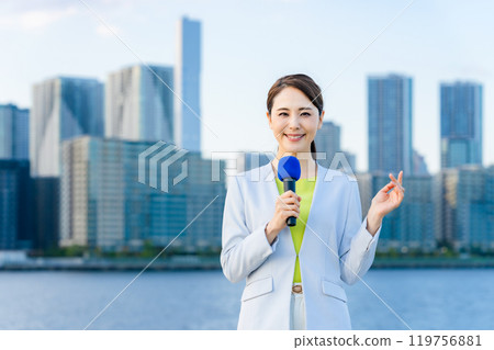 Female announcer standing in front of the city 119756881