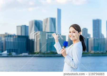 Female announcer standing in front of the city 119756883