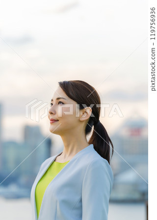 A woman looking far in front of the city A woman looking far in front of the city 119756936